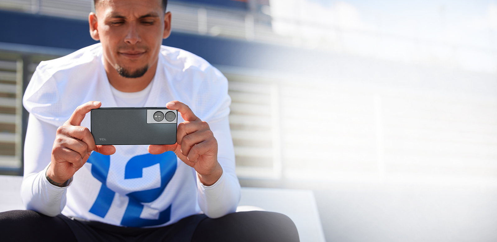 football player watching video on phone