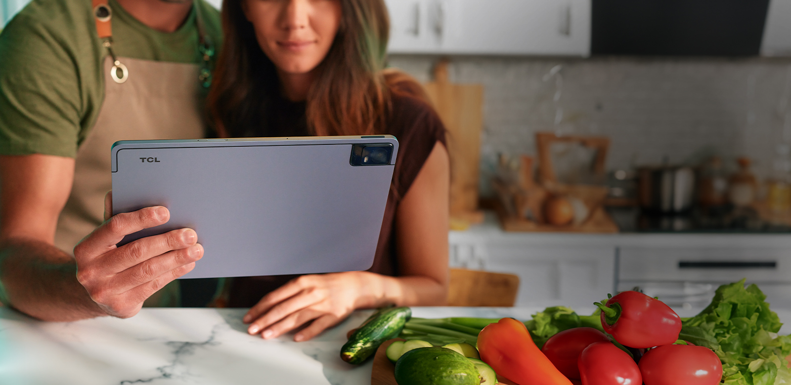 couple photographing meal in kitchen