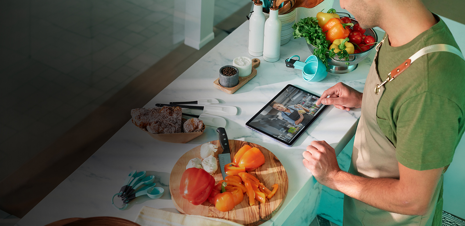 man cooking using tablet